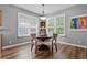 Bright dining area with wood floors, plantation shutters, and a stylish light fixture at 210 Coleton Lane, Deland, FL 32724