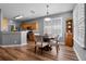 Cozy dining area with wood floors, a pendant light, and bright window at 210 Coleton Lane, Deland, FL 32724