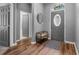 Inviting entryway featuring wood flooring, a decorative door, and a stylish bench at 210 Coleton Lane, Deland, FL 32724