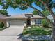 Charming home with a well-manicured lawn and beautiful landscaping, complemented by mature trees at 210 Coleton Lane, Deland, FL 32724