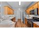 A kitchen showcases wood cabinets, stainless steel appliances, and modern countertops and flooring at 210 Coleton Lane, Deland, FL 32724