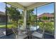 Screened lanai featuring a glass-topped table and four chairs at 210 Coleton Lane, Deland, FL 32724