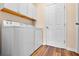 Laundry room shows a washer and dryer with white cabinets and a door with wood-look vinyl plank flooring at 210 Coleton Lane, Deland, FL 32724