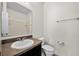 Bathroom with a single vanity, toilet, and a shower visible in the mirror at 2193 Betsy Ross Ln, St Cloud, FL 34769