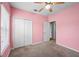 Pink bedroom featuring a closet and ceiling fan at 2193 Betsy Ross Ln, St Cloud, FL 34769