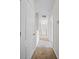Hallway with carpet, white walls, and multiple doors leading to other rooms at 2193 Betsy Ross Ln, St Cloud, FL 34769