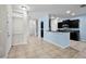 Open-concept living space flows into kitchen with modern black cabinetry and stainless appliances at 2193 Betsy Ross Ln, St Cloud, FL 34769