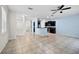 Open living room featuring tile flooring and a kitchen with stainless appliances at 2193 Betsy Ross Ln, St Cloud, FL 34769