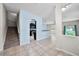 View of the living room with stairs and kitchen with granite counters and stainless appliances at 2193 Betsy Ross Ln, St Cloud, FL 34769
