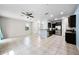 Spacious living room with tile floors flowing into a modern kitchen with stainless appliances at 2193 Betsy Ross Ln, St Cloud, FL 34769