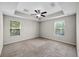 Main bedroom with large windows, neutral carpet, and recessed ceiling at 2193 Betsy Ross Ln, St Cloud, FL 34769
