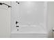 Bathroom featuring a shower-tub combination with white tile surround and black fixtures at 2301 Finwick Ct, Kissimmee, FL 34743