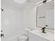 Clean bathroom with modern fixtures, white vanity, and a shower-tub combination at 2301 Finwick Ct, Kissimmee, FL 34743