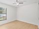 Bright bedroom featuring wood-look flooring, a ceiling fan, and a window at 2301 Finwick Ct, Kissimmee, FL 34743