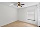 Simple bedroom with a ceiling fan, natural light, and clean, white walls at 2301 Finwick Ct, Kissimmee, FL 34743