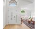 Inviting foyer with decorative glass front door and transom window offering abundant natural light at 2301 Finwick Ct, Kissimmee, FL 34743