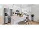 Modern kitchen featuring stainless steel appliances, white cabinets, and island seating at 2301 Finwick Ct, Kissimmee, FL 34743