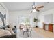 Airy living room featuring vaulted ceilings, neutral furnishings, and a sliding glass door to the backyard at 2301 Finwick Ct, Kissimmee, FL 34743