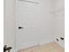 Storage area with tile flooring, shelving, and a white door at 2301 Finwick Ct, Kissimmee, FL 34743