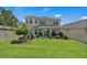 Spacious backyard with lush green lawn, patio, and well-maintained landscaping at 2845 High Pointe St, Clermont, FL 34711