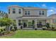 Well-manicured backyard featuring a covered patio, lush lawn, and beautiful landscaping for outdoor enjoyment and relaxation at 2845 High Pointe St, Clermont, FL 34711