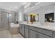 Bright bathroom features a double vanity, soaking tub, and separate glass shower at 2845 High Pointe St, Clermont, FL 34711