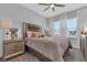 Charming bedroom with a plush bed, side tables, and bright windows at 2845 High Pointe St, Clermont, FL 34711