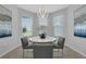 Cozy dining area featuring a round table with seating for four and bright natural light from surrounding windows at 2845 High Pointe St, Clermont, FL 34711