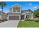Charming two-story home showcasing a gray exterior, manicured lawn and complemented by a two-car garage at 2845 High Pointe St, Clermont, FL 34711