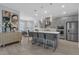 Modern kitchen with gray cabinets, a large island, stainless steel appliances, and an adjacent dining area at 2845 High Pointe St, Clermont, FL 34711