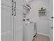 Convenient laundry room with washer, dryer, storage cabinets, and shelving at 2845 High Pointe St, Clermont, FL 34711