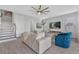 Comfortable living room with neutral tones, plush seating, a ceiling fan, and modern decor at 2845 High Pointe St, Clermont, FL 34711
