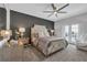 Luxurious main bedroom with a decorative headboard, ceiling fan, and access to an outdoor balcony at 2845 High Pointe St, Clermont, FL 34711