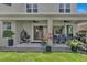 Outdoor patio area with dining set, ceiling fans, and beautiful garden features at 2845 High Pointe St, Clermont, FL 34711