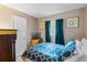 Comfortable bedroom with blue patterned bedding, a TV, and bright natural light at 2904 Allison Dr, Orlando, FL 32826