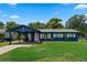 Charming single-story home with a well-maintained lawn and covered carport with a lovely blue exterior at 2904 Allison Dr, Orlando, FL 32826
