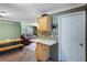 Open kitchen leading into the living room with bright natural light, tiled floors, and room for a dining area at 2904 Allison Dr, Orlando, FL 32826