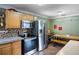 Functional kitchen area with stainless steel appliances, wood cabinets, and a dining space for casual meals at 2904 Allison Dr, Orlando, FL 32826