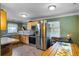 Efficient kitchen with stainless steel appliances, including a refrigerator and oven, with natural wood cabinets at 2904 Allison Dr, Orlando, FL 32826