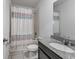 Bathroom featuring granite vanity, an oval sink, and a shower-tub combo at 29400 Caspian St, Leesburg, FL 34748