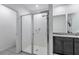Modern bathroom featuring a glass-enclosed shower, granite countertops and double sink vanity at 29400 Caspian St, Leesburg, FL 34748