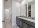 Modern bathroom with double vanities, granite countertop, and tiled floors at 29400 Caspian St, Leesburg, FL 34748