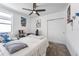 Comfortable bedroom features plush carpet, a ceiling fan, and a large window for plenty of natural light at 29400 Caspian St, Leesburg, FL 34748