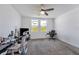 Bright bedroom featuring carpeted flooring, a ceiling fan and windows providing plenty of natural light at 29400 Caspian St, Leesburg, FL 34748