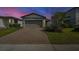 Charming single-Gathering home with a well-maintained lawn, brick driveway, and attached two-car garage at 29400 Caspian St, Leesburg, FL 34748