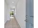 Inviting hallway with tile flooring leading into an open living area with lots of natural light at 29400 Caspian St, Leesburg, FL 34748