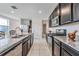 Modern kitchen with dark cabinets, granite countertops and stainless steel appliances at 29400 Caspian St, Leesburg, FL 34748