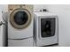 Convenient laundry area with a white, front-loading washer and dryer at 29400 Caspian St, Leesburg, FL 34748