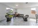 Cozy living room featuring tile flooring, large windows, and comfortable seating arrangements at 29400 Caspian St, Leesburg, FL 34748