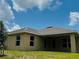 View of the backyard of the home featuring green grass, a patio, and tan siding at 4326 Sagefield Dr, Harmony, FL 34773